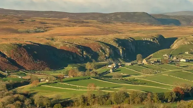 Cottages in the countryside surrounded by hills in Holwick, in the Teesdale Valley